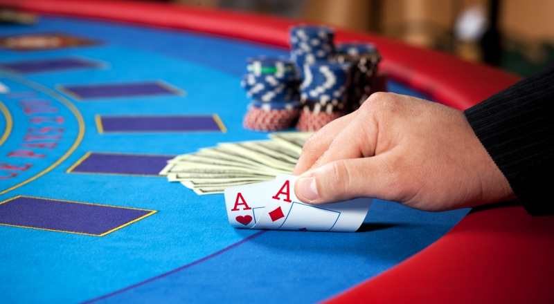 4586711-hand-with-chips-and-banknotes-on-table